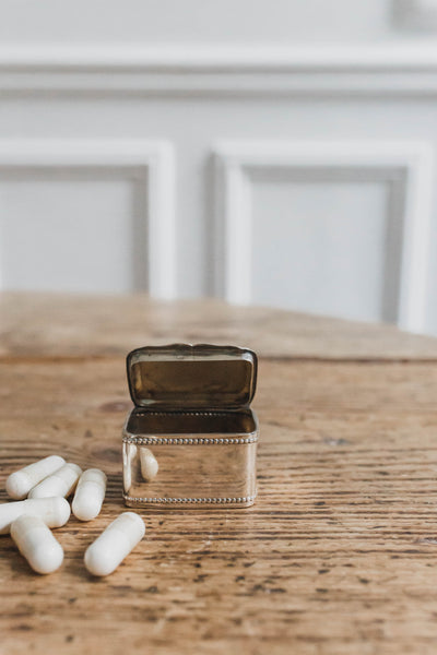 A small group of modern silver pill boxes and other various pill
