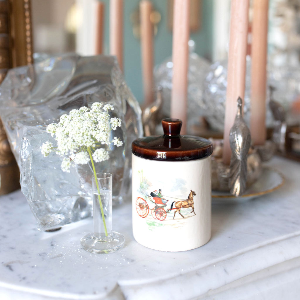 Antique jar with horse drawn carriage